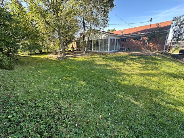 view of yard with a sunroom