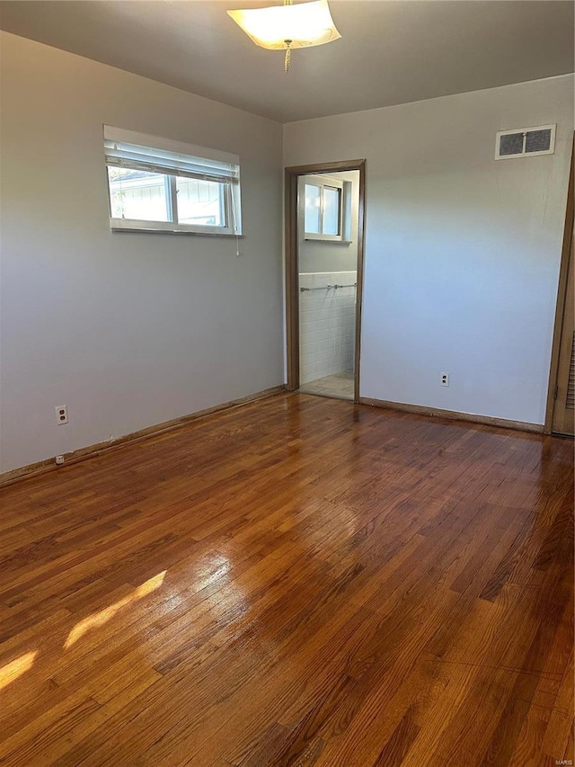 spare room with hardwood / wood-style floors