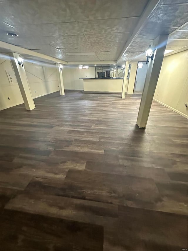 basement featuring dark hardwood / wood-style flooring