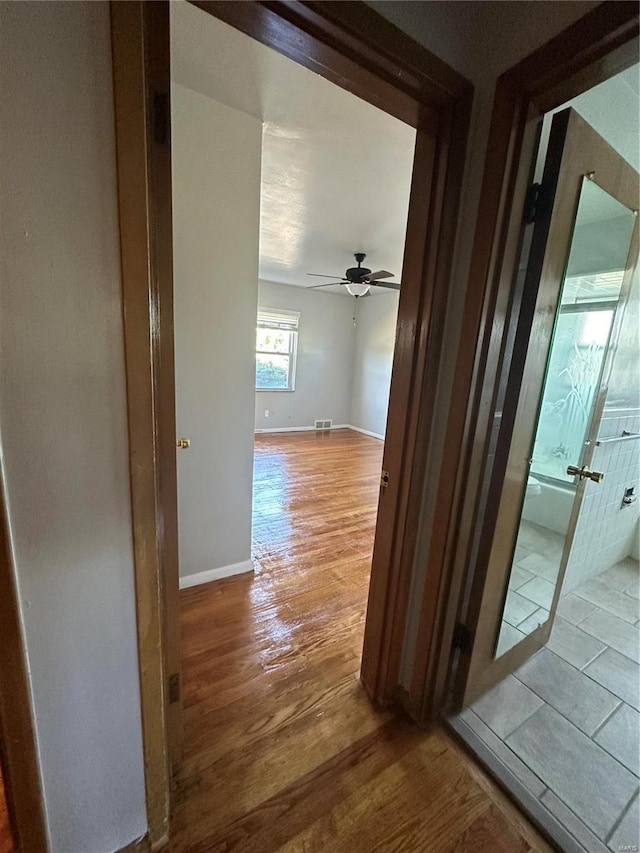 hallway with hardwood / wood-style floors