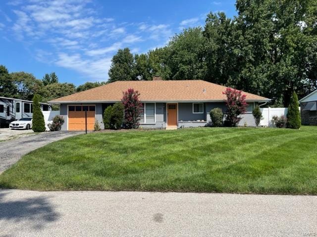 single story home featuring a garage and a front yard