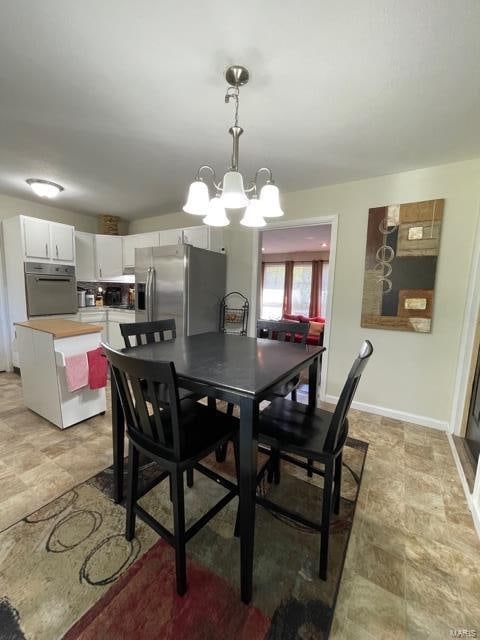 dining area featuring an inviting chandelier