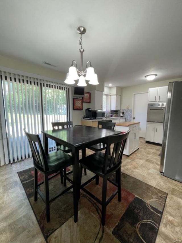 dining space featuring a chandelier