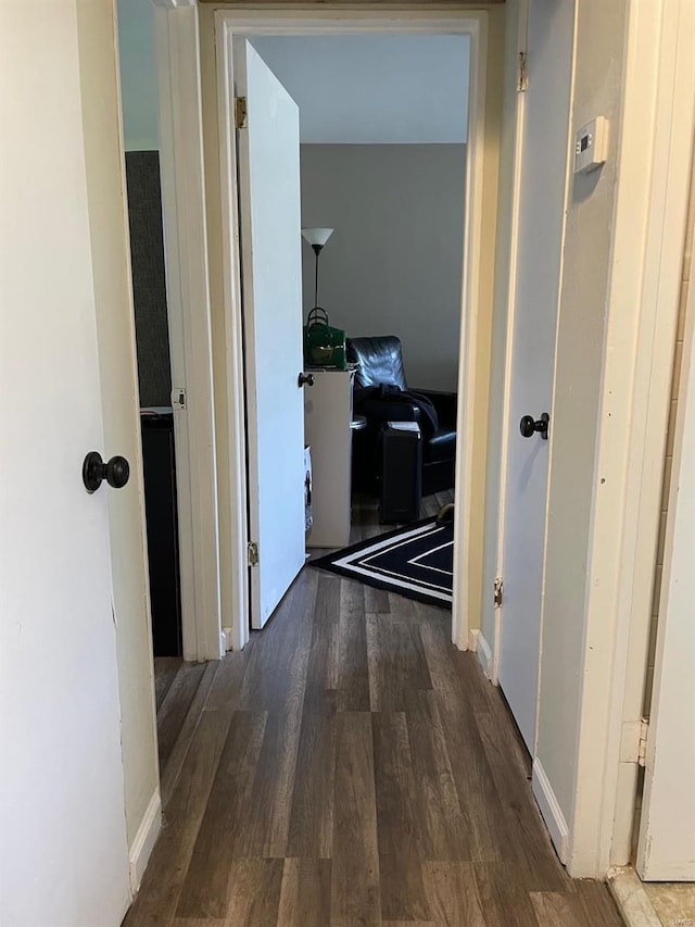 corridor featuring dark wood-type flooring