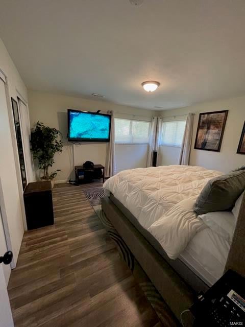 bedroom with dark hardwood / wood-style floors