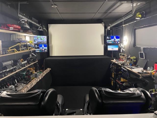 cinema room featuring a paneled ceiling