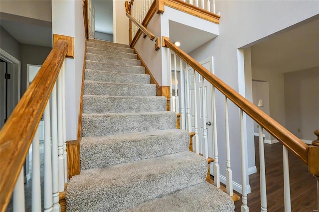 staircase with hardwood / wood-style flooring