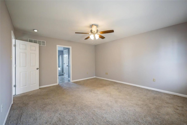 carpeted empty room featuring ceiling fan