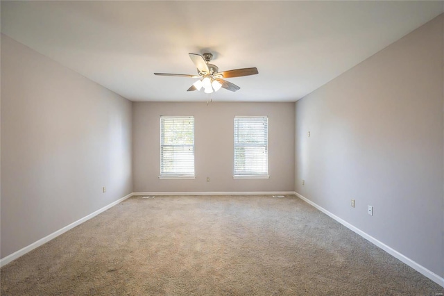 carpeted spare room featuring ceiling fan