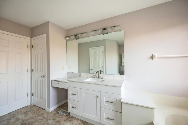 bathroom with vanity and a tub to relax in