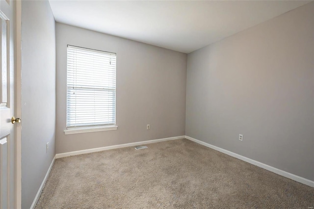 carpeted empty room featuring plenty of natural light