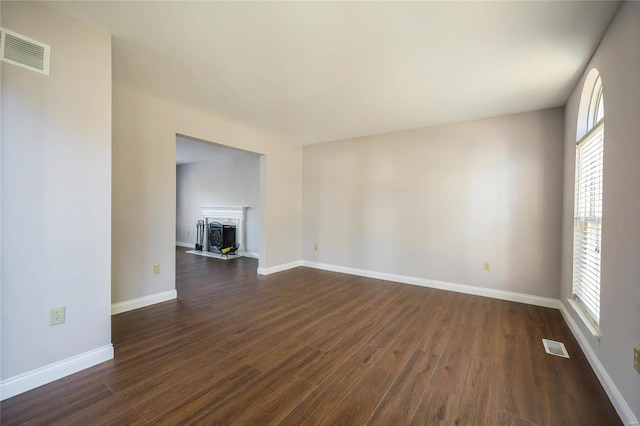 unfurnished living room with dark hardwood / wood-style floors