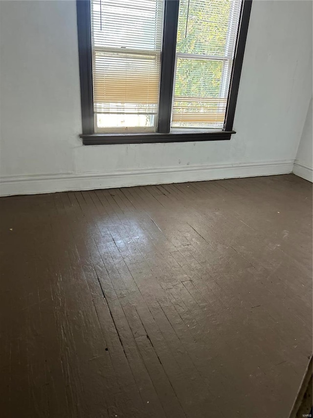 empty room featuring dark hardwood / wood-style flooring