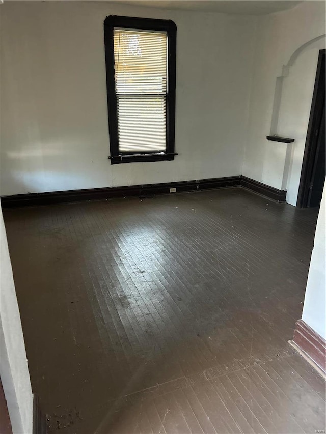 spare room with dark wood-type flooring