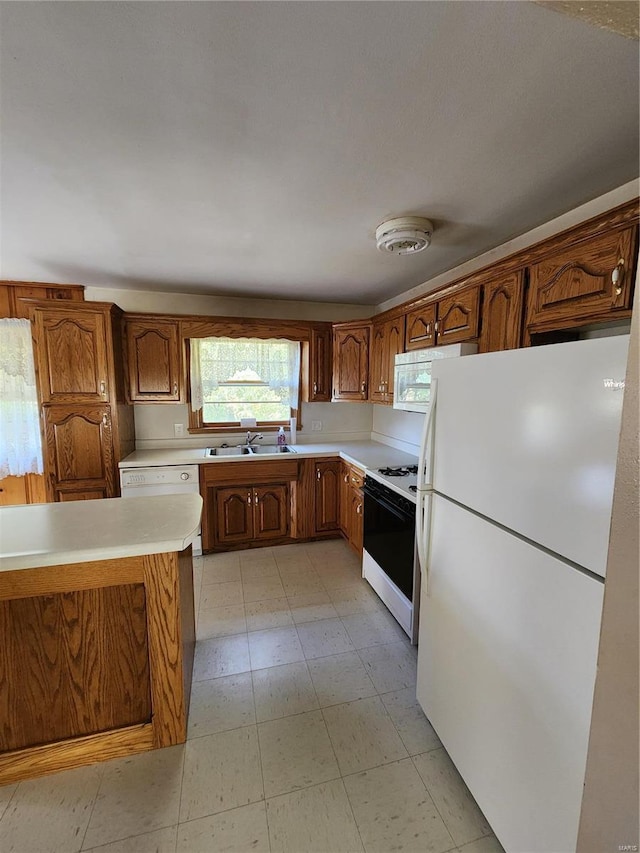 kitchen with white appliances and sink