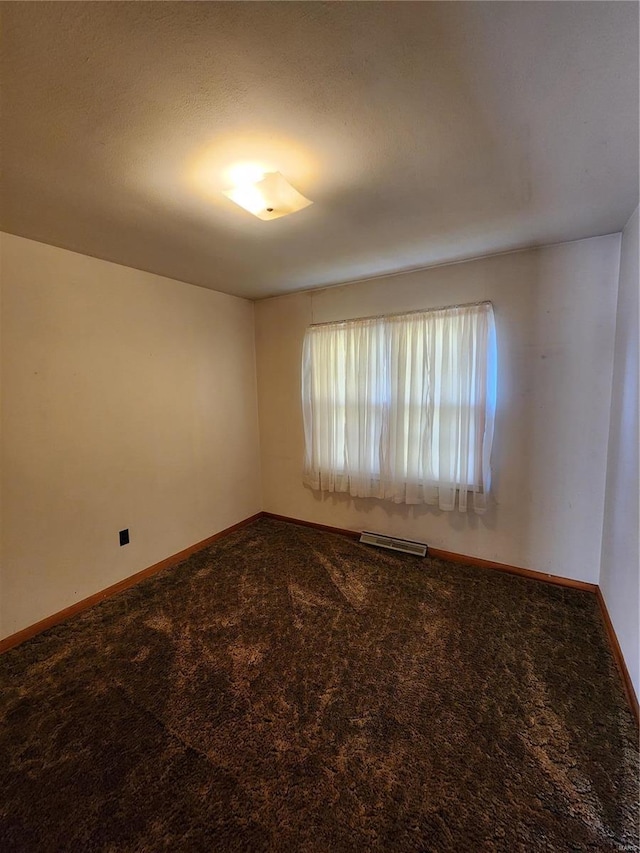 carpeted spare room featuring a textured ceiling