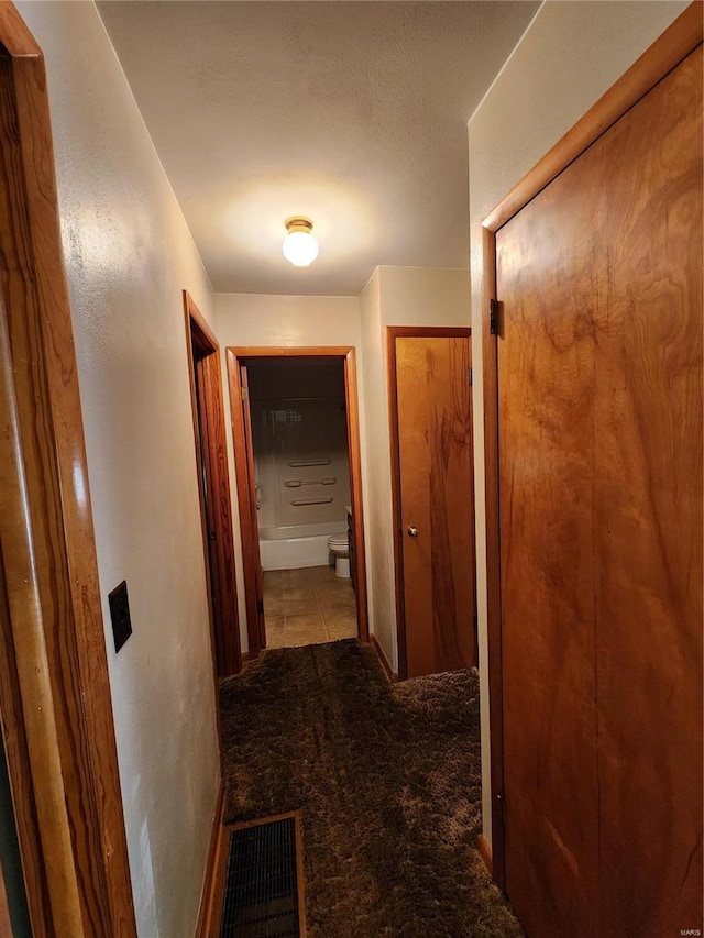 corridor featuring light tile patterned floors