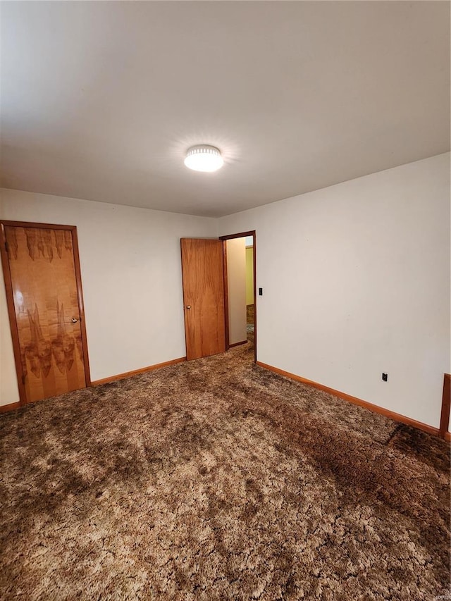 unfurnished room featuring carpet