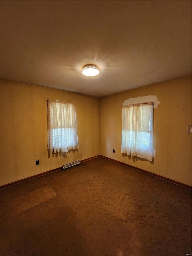 carpeted spare room featuring a wealth of natural light