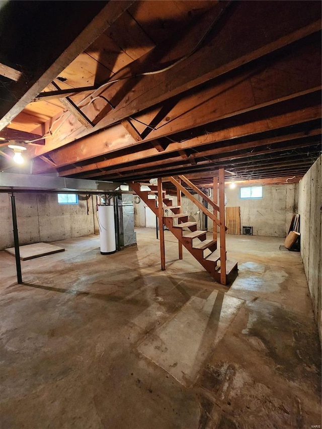 basement featuring water heater and a wealth of natural light