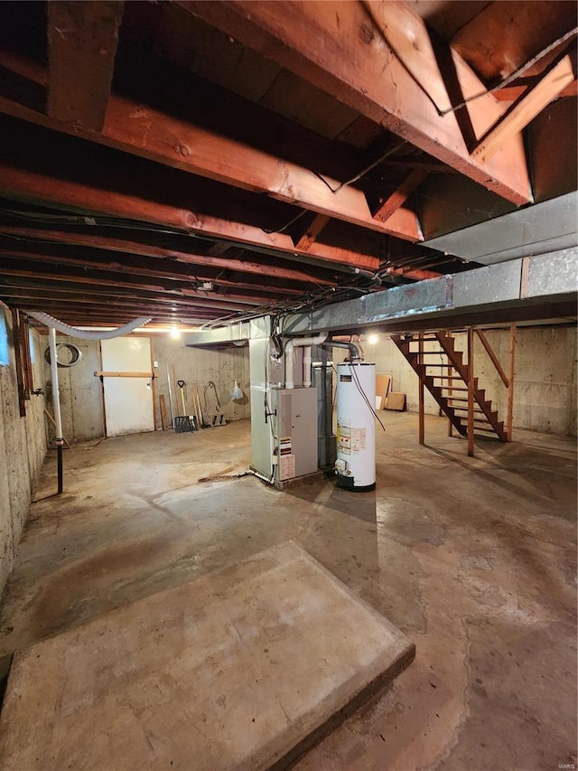 basement featuring heating unit and water heater