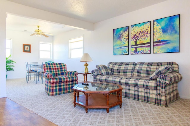 living room featuring light carpet and ceiling fan