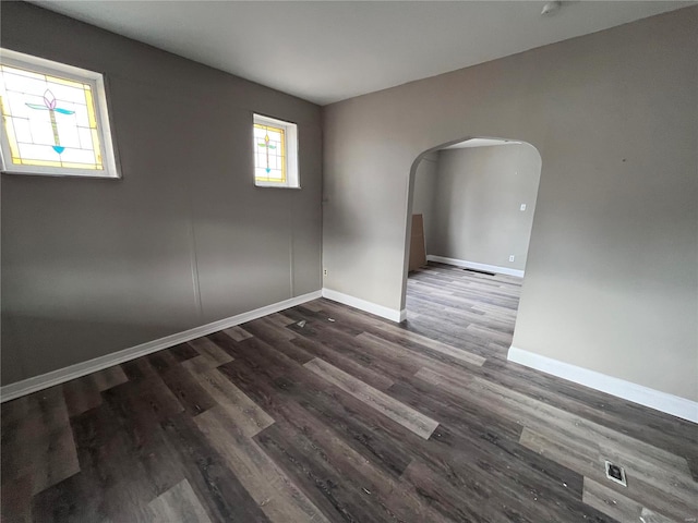 empty room with dark hardwood / wood-style flooring