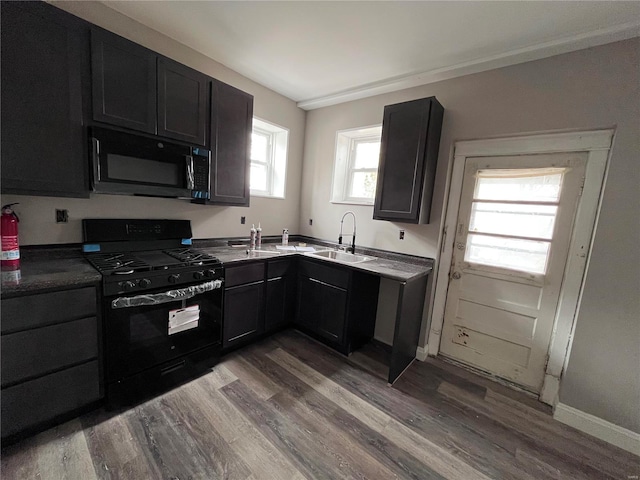 kitchen with sink, light hardwood / wood-style floors, plenty of natural light, and black range with gas cooktop