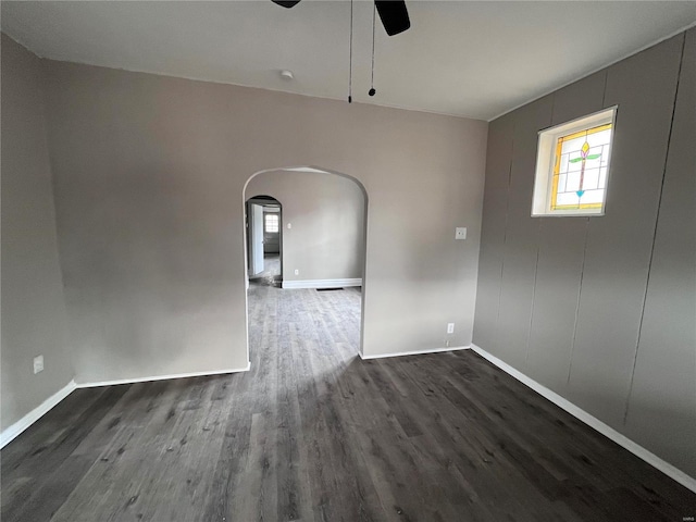 unfurnished room with dark hardwood / wood-style floors and ceiling fan