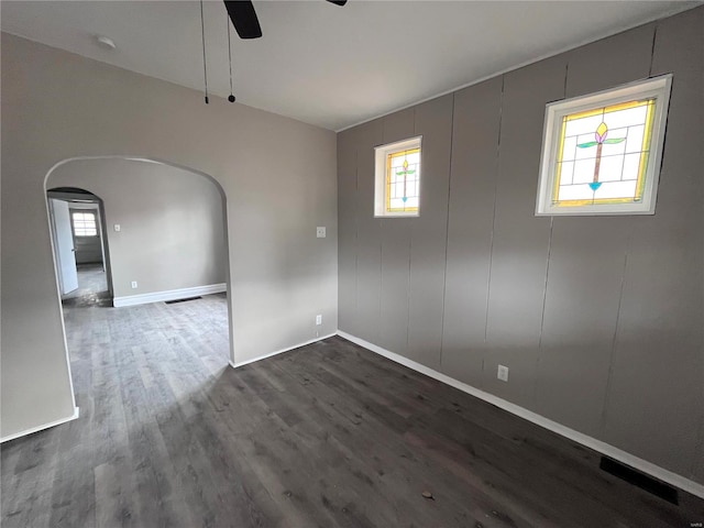 unfurnished room featuring ceiling fan and dark hardwood / wood-style floors