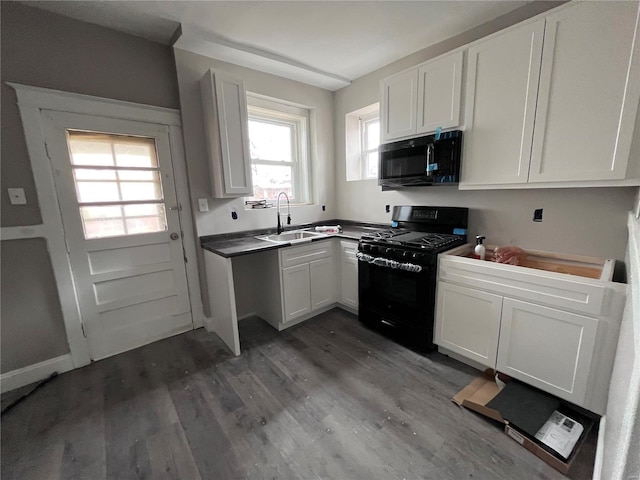 kitchen with dark hardwood / wood-style flooring, sink, white cabinets, and black appliances