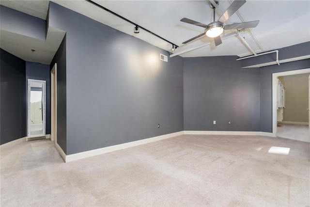 empty room with light carpet, baseboards, rail lighting, visible vents, and ceiling fan