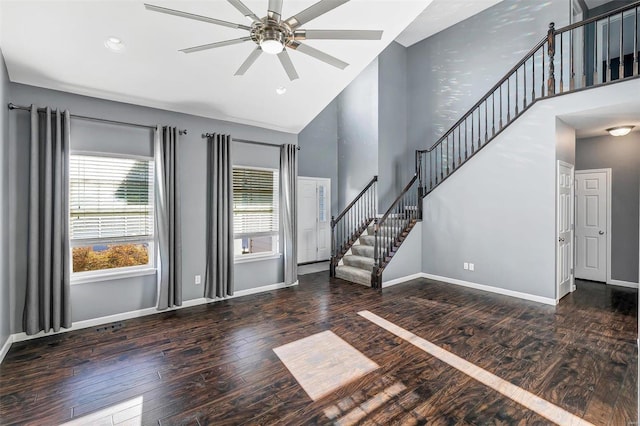 foyer entrance featuring dark wood-type flooring, ceiling fan, and vaulted ceiling