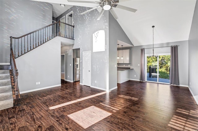 unfurnished living room with ceiling fan, high vaulted ceiling, and dark hardwood / wood-style floors