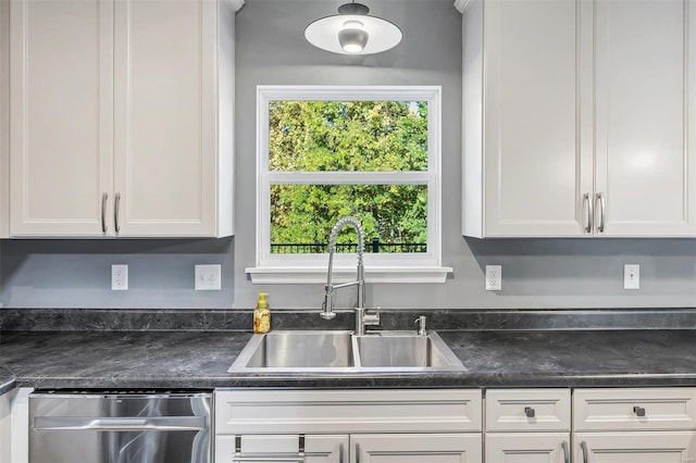 kitchen with white cabinetry, sink, and plenty of natural light