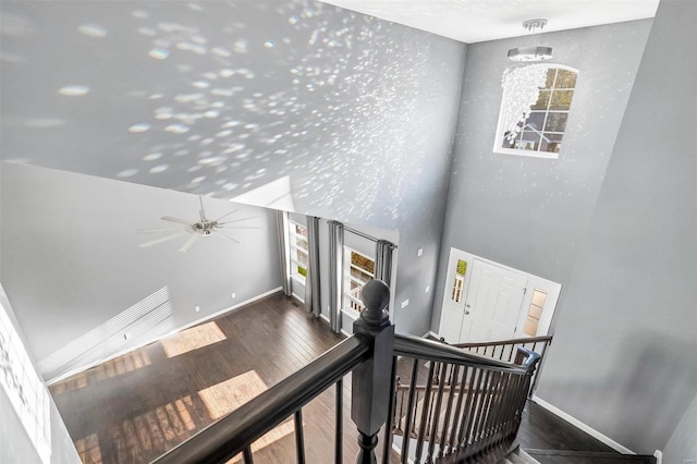 stairway featuring wood-type flooring and ceiling fan