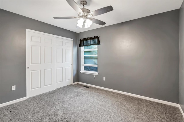 unfurnished bedroom featuring a closet, ceiling fan, and carpet flooring