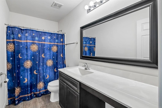 bathroom featuring vanity, a shower with shower curtain, and toilet