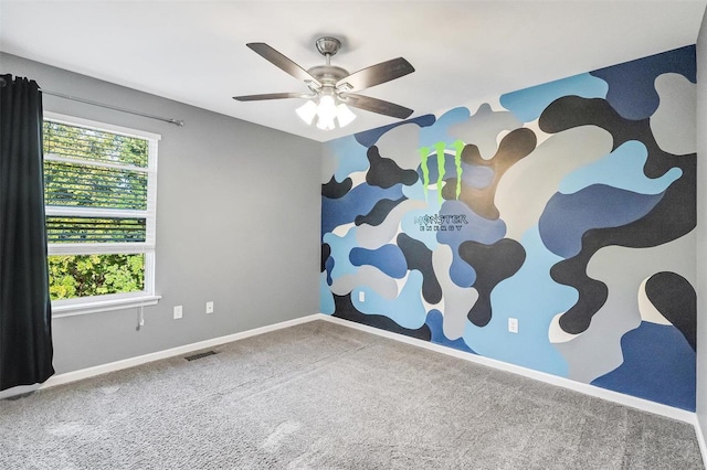 carpeted spare room with ceiling fan