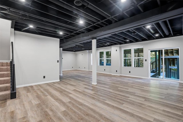 basement with light hardwood / wood-style floors