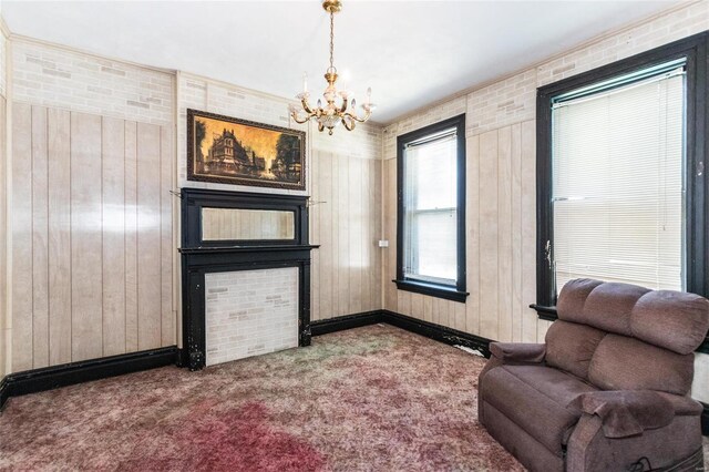 sitting room featuring carpet floors and wooden walls