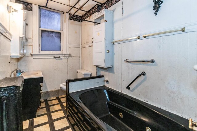 bathroom featuring vanity, toilet, and a bathing tub