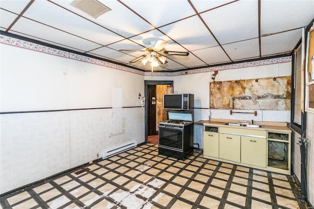 kitchen featuring a baseboard heating unit, sink, white range with gas stovetop, tile walls, and ceiling fan