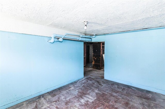 basement featuring a textured ceiling