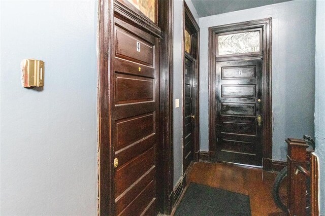 doorway with dark wood-type flooring