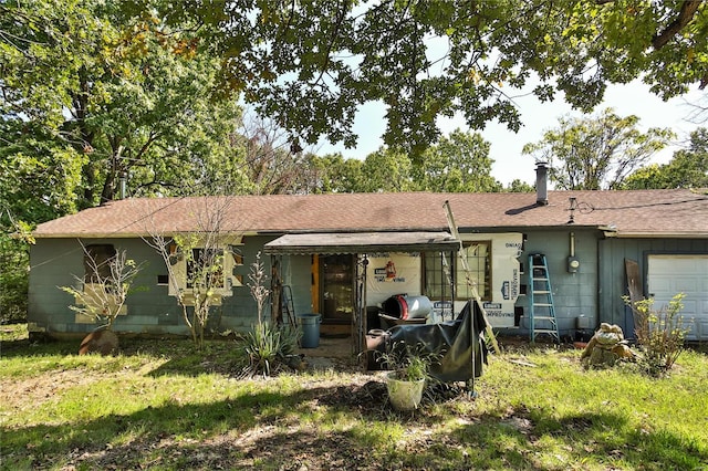 rear view of property with a garage