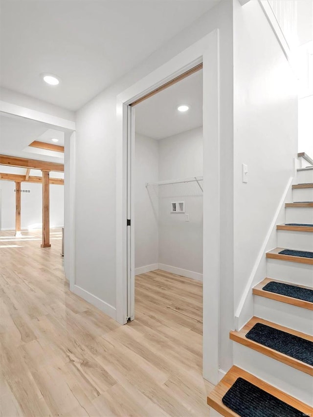 hallway with light hardwood / wood-style flooring