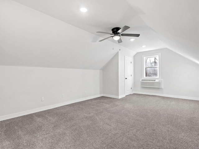 bonus room featuring ceiling fan, carpet floors, a wall unit AC, and vaulted ceiling