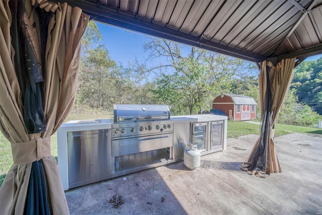 view of patio featuring grilling area and a shed