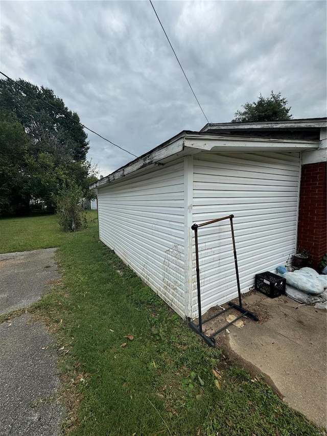 view of side of home featuring a lawn